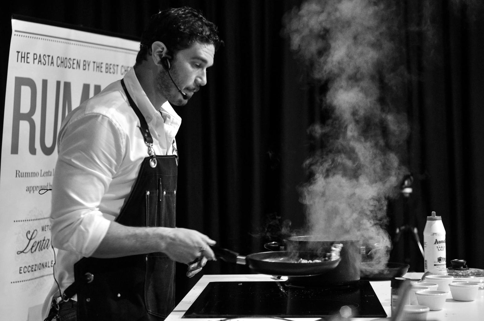Sean Gravina cooking live on stage at a pasta demonstration